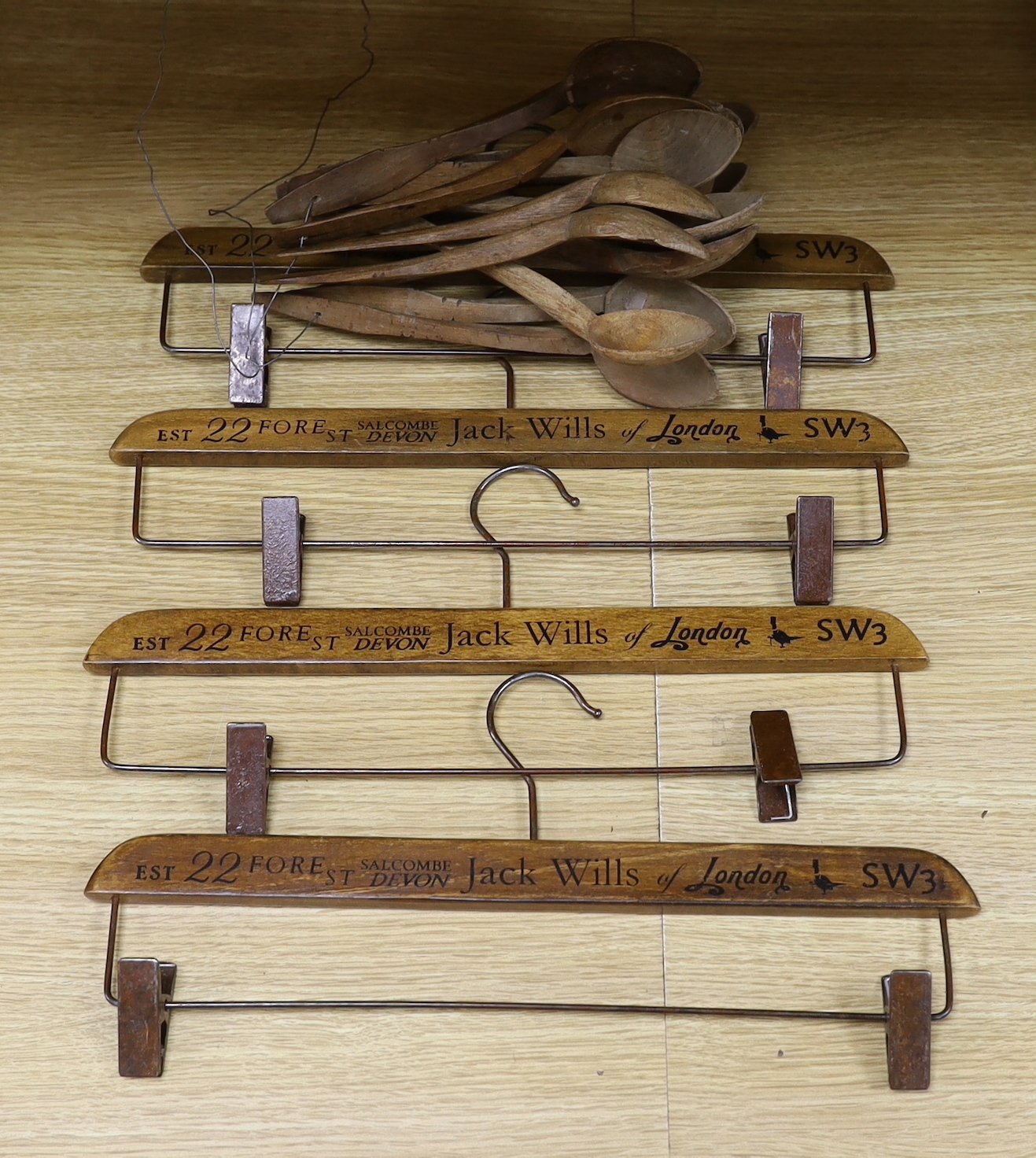 A quantity of Victorian carved wood spoons and four Jack Wills clothes hangers
